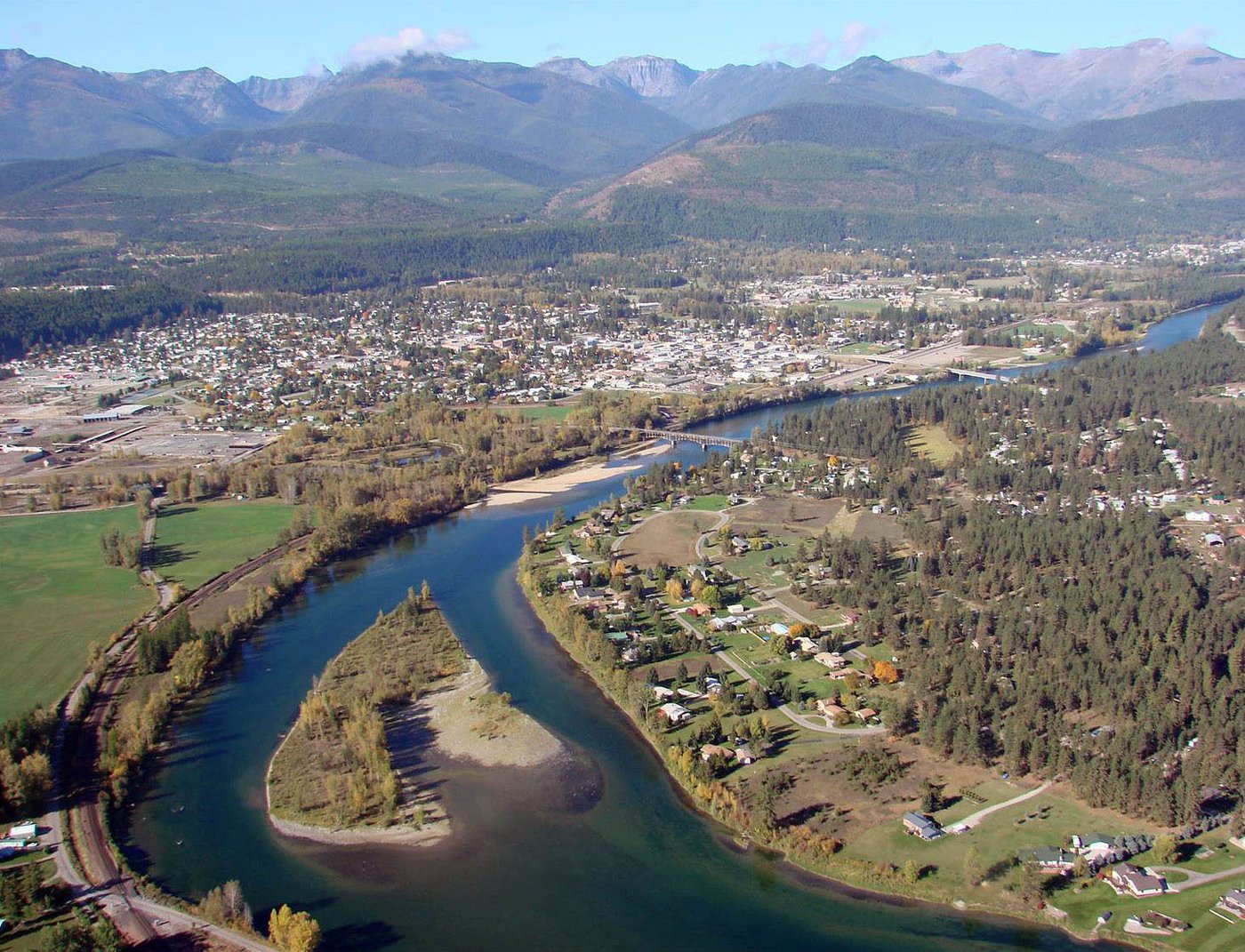 Aerial view of Libby, Montana nestled in the Kootenai River valley, surrounded by the Cabinet Mountains.