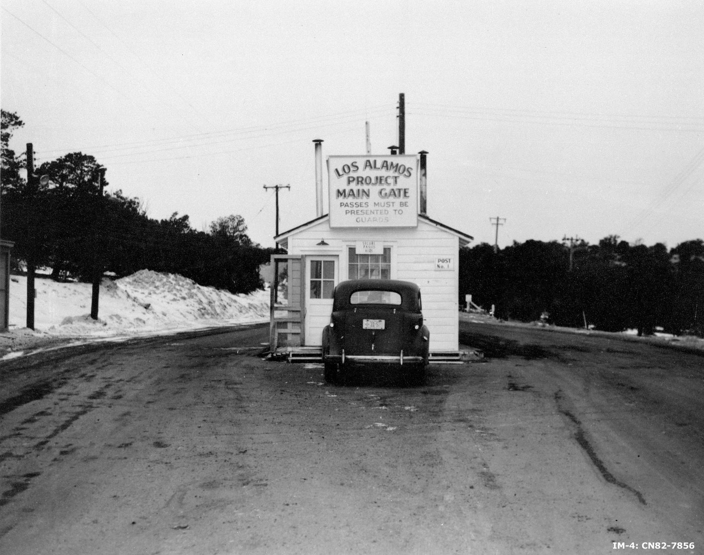 The main security gate to Project Y at Los Alamos, New Mexico, 1943. The checkpoint where the outside world ended and The Hill began.